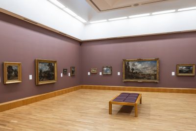 museum room with historical paintings