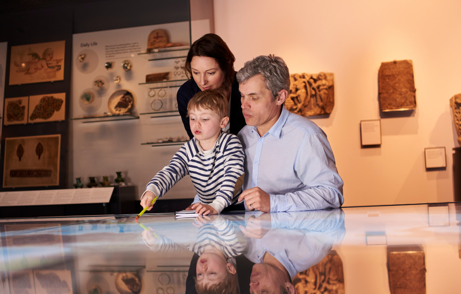 three people at a interactive exhibition at a museum