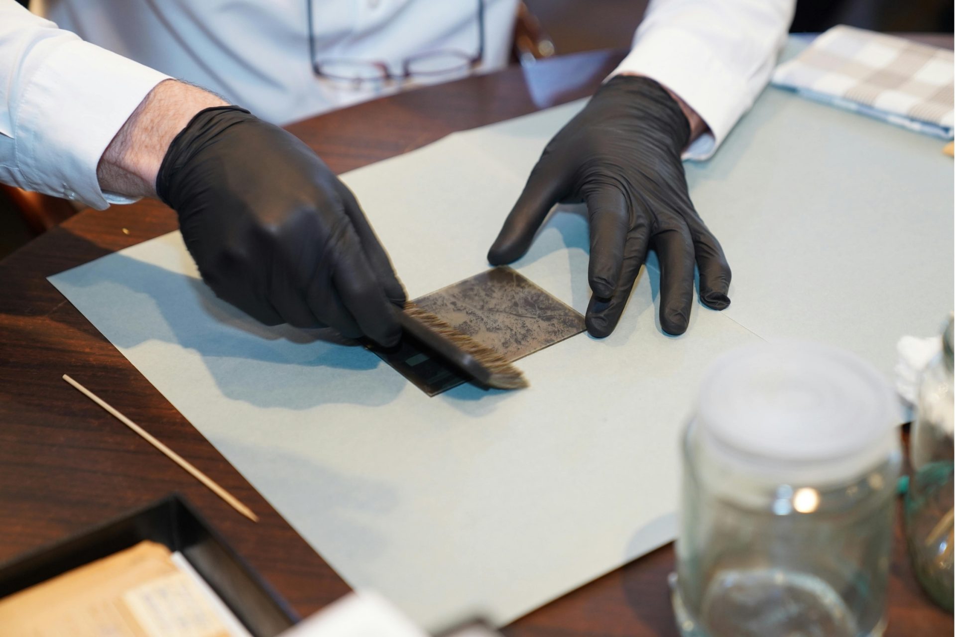 museum archivist working on restoring an artwork.