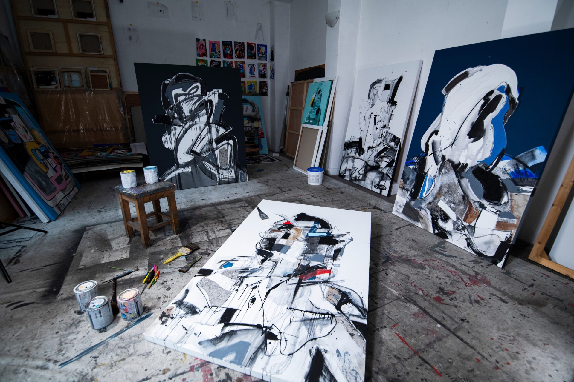 art studio with several abstract paintings