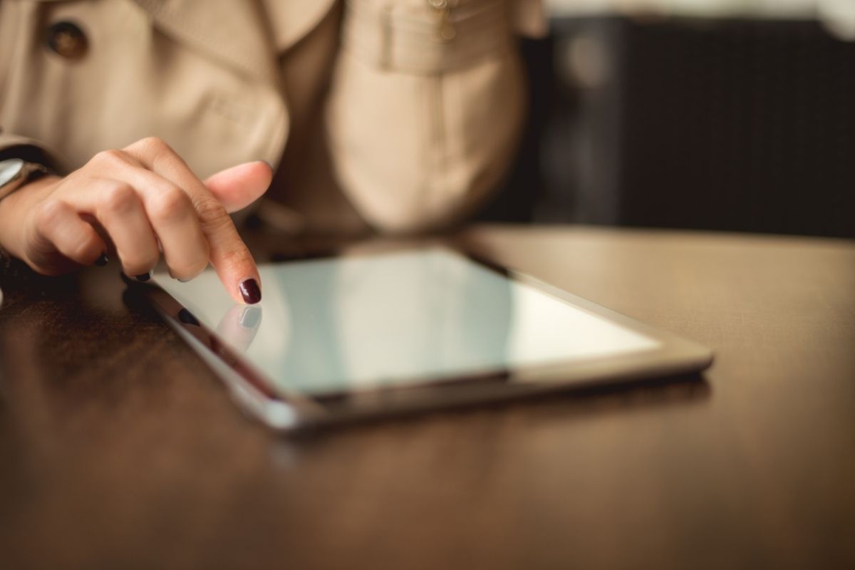 person reviewing information on a small tablet.