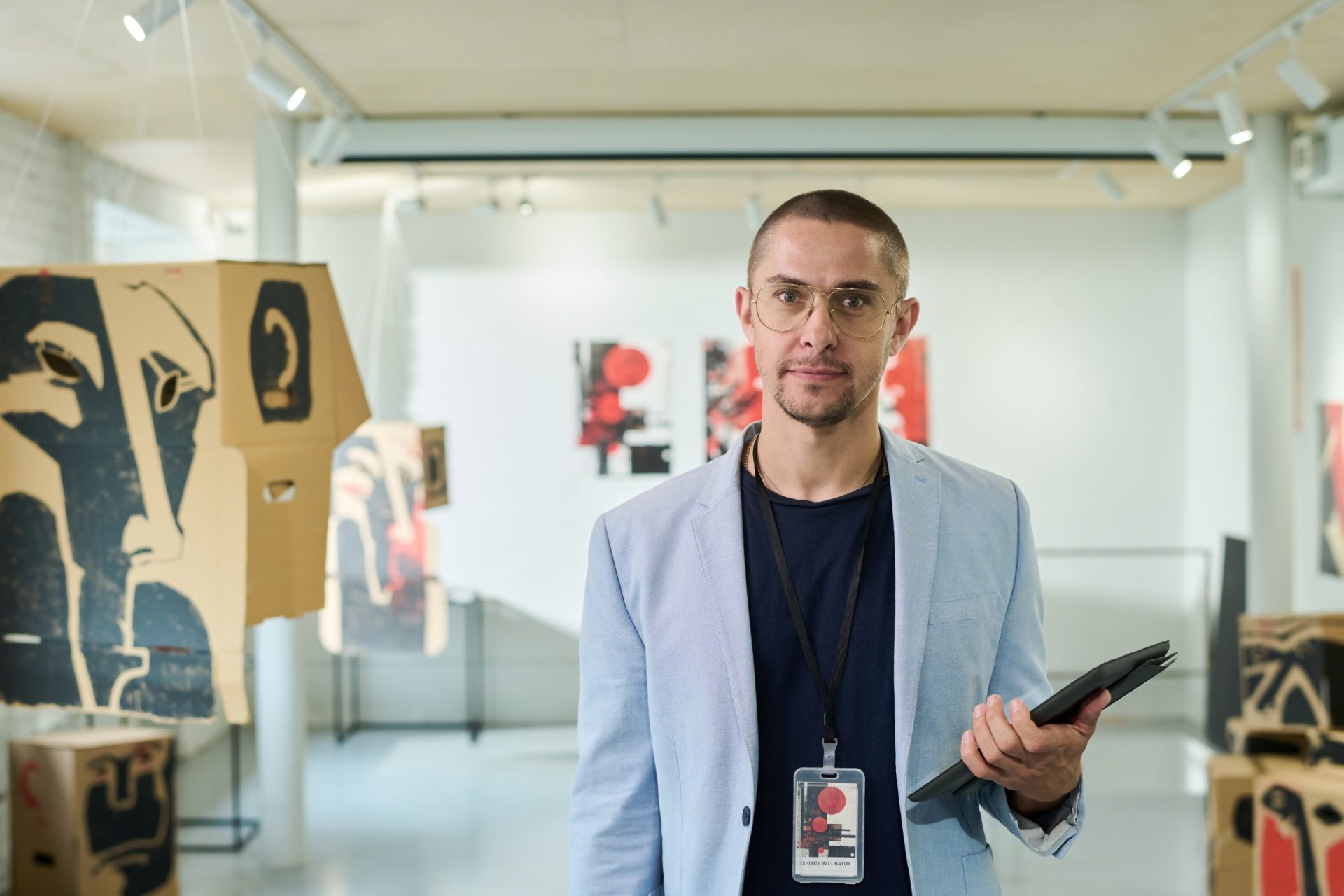 gallerist at art fair holding ipad