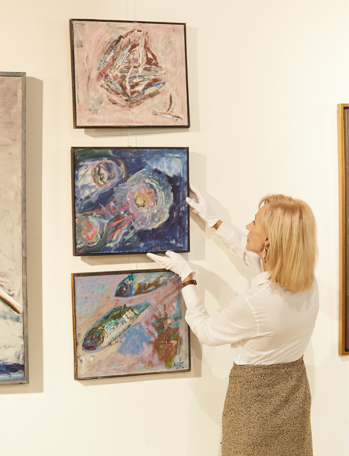 registrar installing paintings.