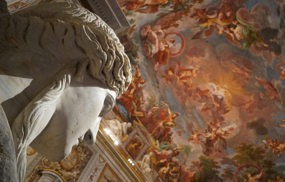 A marble sculpture viewed from below against an ornate frescoed ceiling, representing fine art objects requiring centralised and accurate collection records