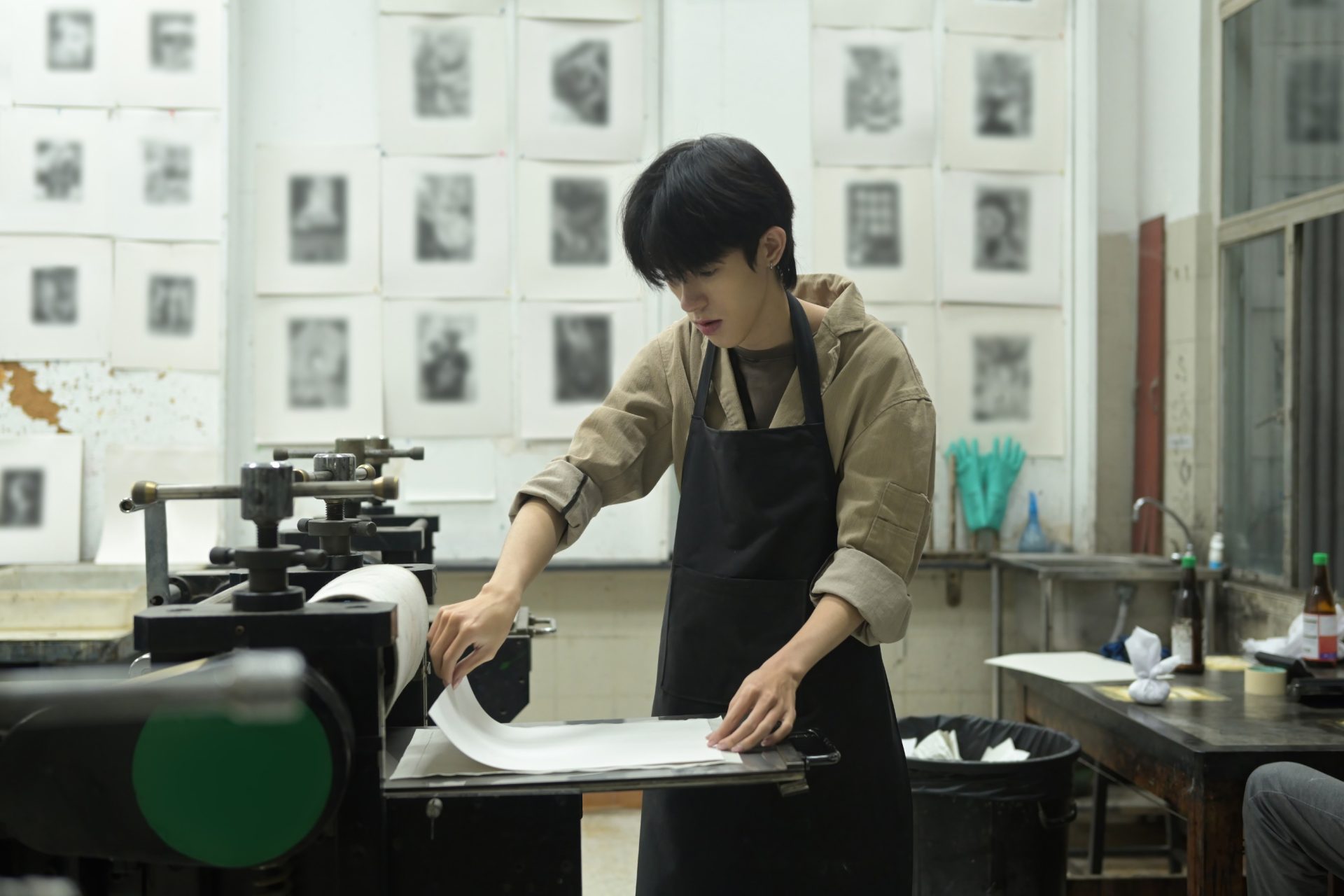 printmaker working at a press