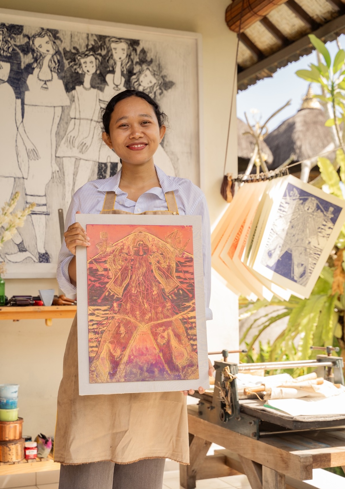 printmaker making a new print in outdoor studio.