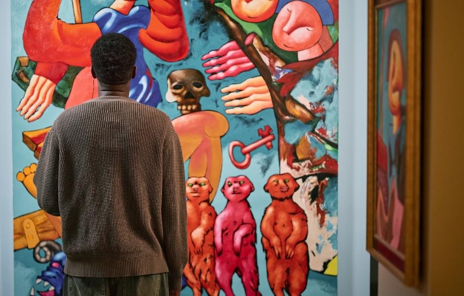 Visitor viewing a large contemporary painting in a gallery, representing the artwork records and media assets institutions manage with Gallery Systems.
