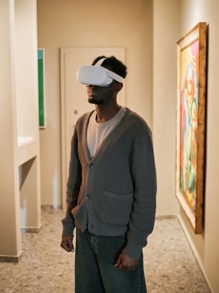 Visitor wearing a VR headset in a gallery, representing the time-based media collections institutions manage and share with Gallery Systems.