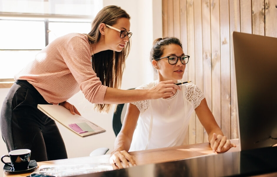 Gallery professionals working together on a computer