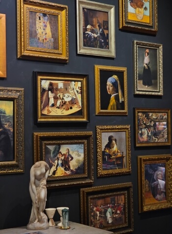 Art collection framed and hung on wall