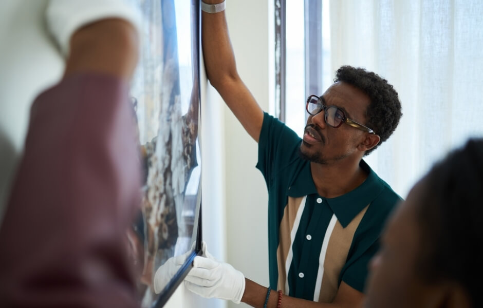 Gallery workers installing artwork